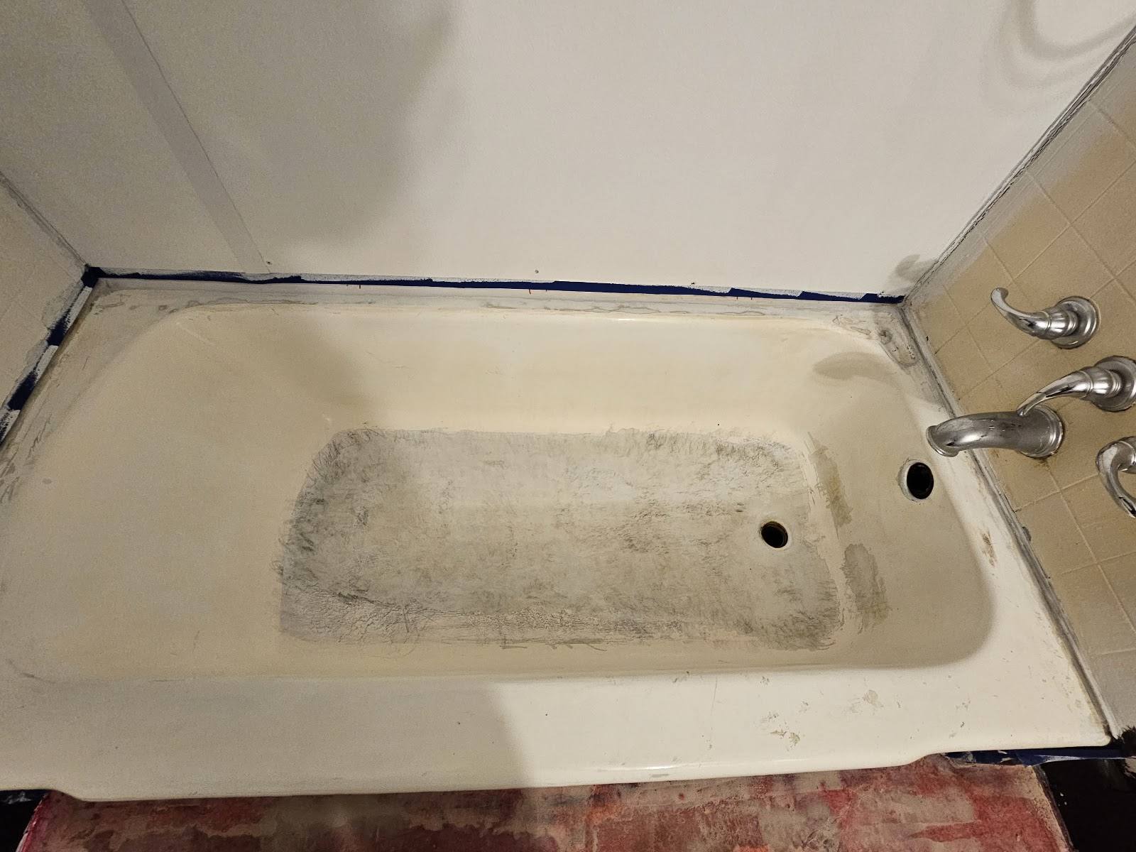 The same bathtub during surface preparation before refinishing