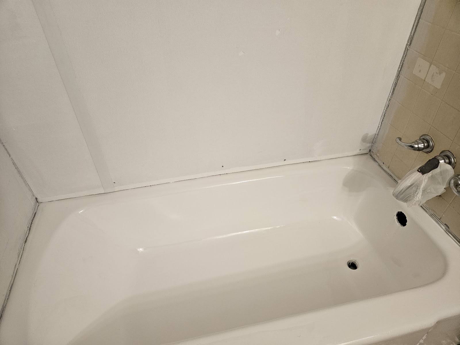 The same bathtub with a fresh glossy white refinished surface