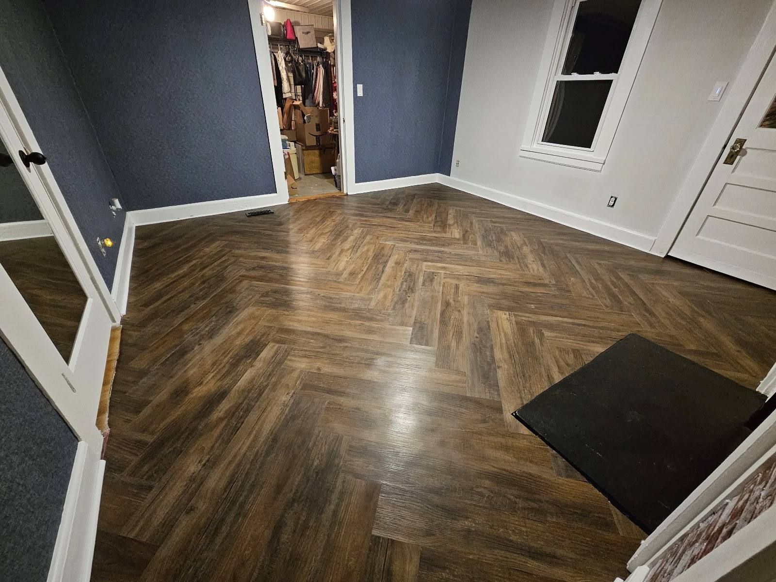Second view of the completed dark walnut herringbone floor