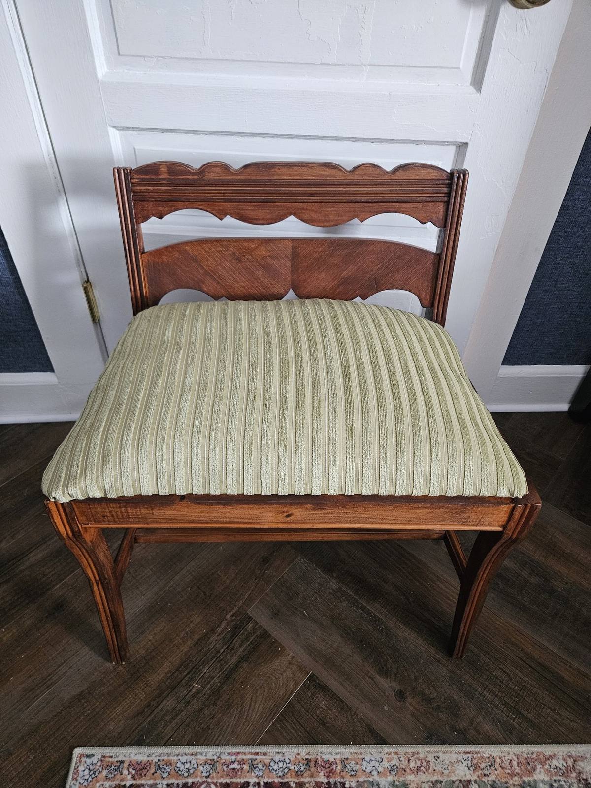 Vintage vanity bench after the wood was refreshed and the seat reupholstered in green striped fabric